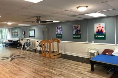 Carrollton Nursing & Rehab Ctr, Nursing Home in Carrollton, GA — Rehabilitation gym with equipment and motivational posters
