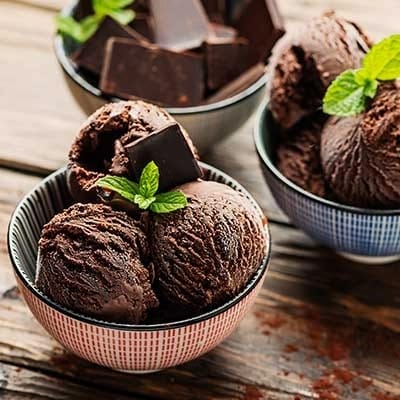 Bowls of chocolate ice cream topped with mint leaves