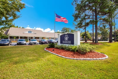 Exterior view of Charter Senior Living at Southern Pines with landscaping