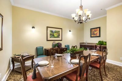 Dining room with a large wooden table and chandelier