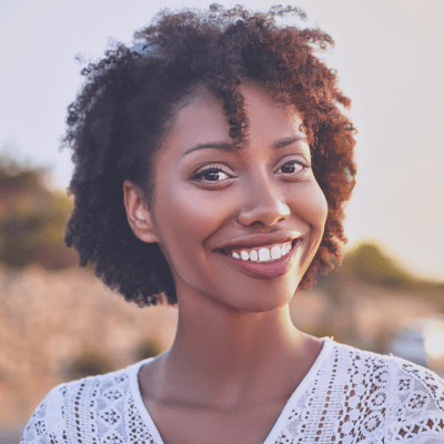 Tranquility of Cartersville, nursing home in Cartersville, GA — Smiling woman with curly hair in natural setting