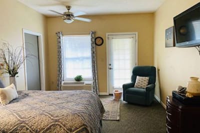 Cozy resident room with a bed and chair