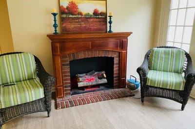Cozy interior with wicker chairs and fireplace