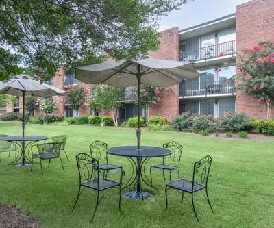 Outdoor seating area with tables and umbrellas