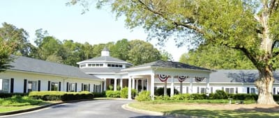 Exterior view of a senior living facility in a landscaped setting
