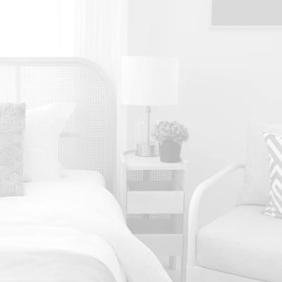 Cozy bedroom setup with a bedside table and lamp