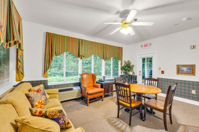 Bright interior common area with seating and a table