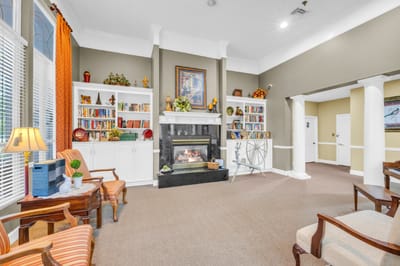 Cozy common area with bookshelves and a fireplace