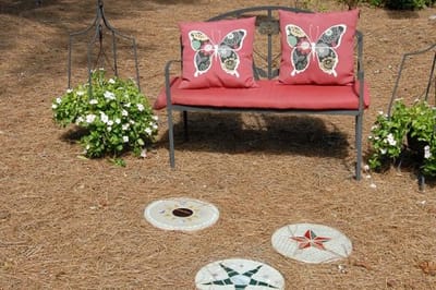 Outdoor sitting area with decorative pillows and stones