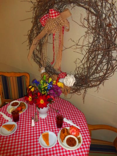 Dining table with meal plates and floral arrangement