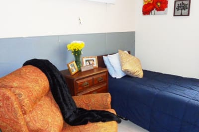 Cozy resident room with floral decorations and a chair