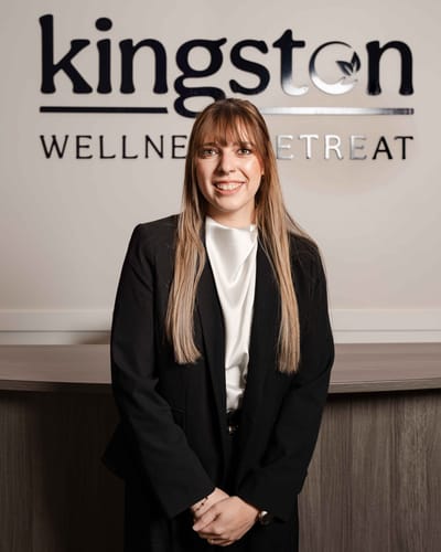 Staff member posing in front of the reception area