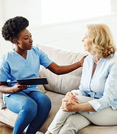 Caregiver interacting with a resident in a cozy sitting area