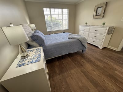 Cozy private resident room with a bed and dresser