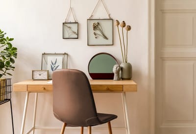 A stylized desk with decor in a minimalist room