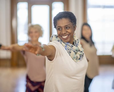 Residents engaged in a joyful movement activity in a spacious room