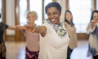 A group of seniors participating in a joyful dance class