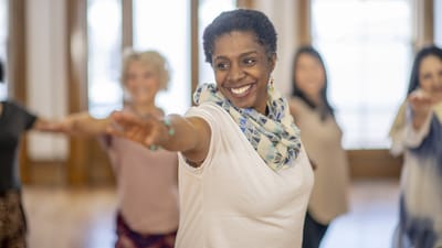 Residents participating in a dance activity in a bright room