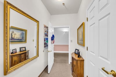 Interior hallway with mirrors and portraits