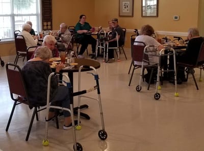 Residents enjoying meals in a dining area