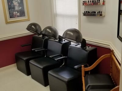 Salon area with hair dryers and seating