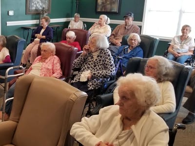 Residents gathered in a common area for a group activity
