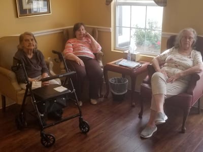 Residents chatting in a cozy common area