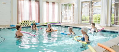Residents participating in a water aerobics class