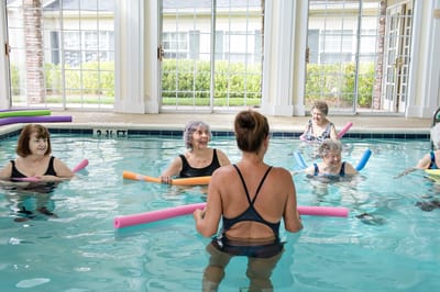 Seniors participating in an aquatic exercise class in a pool
