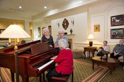 Residents enjoying a musical performance in a common area