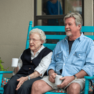Residents enjoying coffee on a porch