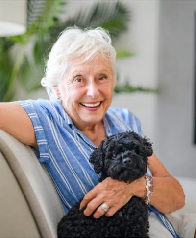 Smiling senior woman with a small dog