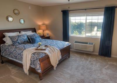 Cozy resident room with bed, window, and decor