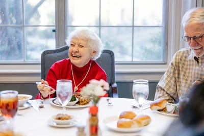 Elderly residents enjoying a meal together.