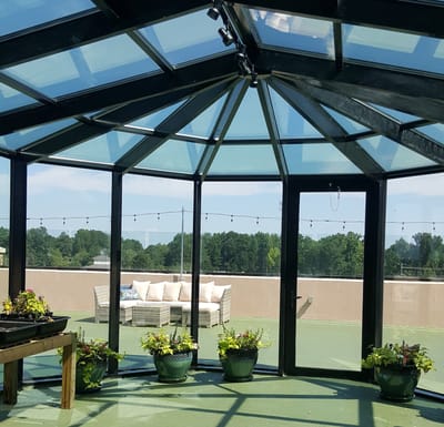 A sunlit indoor space with seating and plants