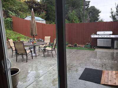 Outdoor patio area with seating and barbecue grill