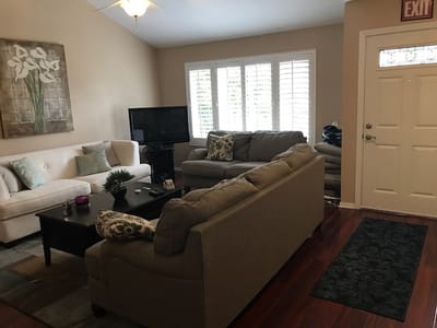 Bright common area with seating and TV