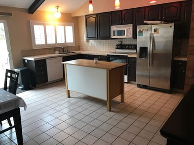 Bright kitchen area with modern cabinetry and appliances