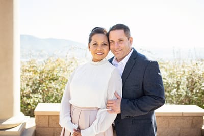 Couple posing in a sunny outdoor setting
