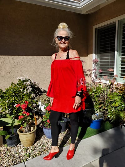 Resident enjoying the garden in a stylish red outfit