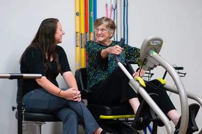 A resident engages with staff during therapy session
