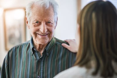 Senior resident smiling at caregiver