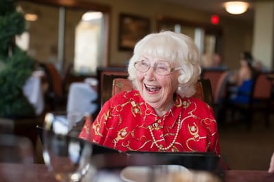 Happy resident enjoying time in a dining area