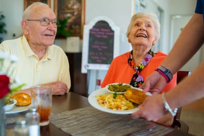 Residents enjoying a meal in the dining room