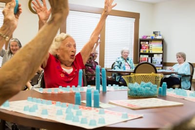 Residents excitedly playing a game in a common area