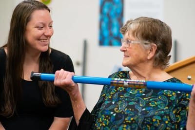 Resident enjoying an activity with staff member
