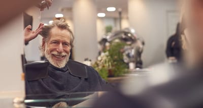 Senior man enjoying a hair treatment in the salon