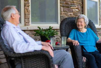 Two residents enjoying the outdoors on a patio