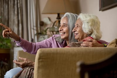 Two residents enjoying a moment together in a cozy common area