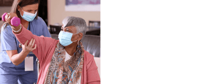 A staff member assisting a resident with exercises